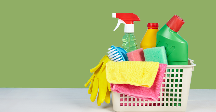 A white basket filled with cleaning products.