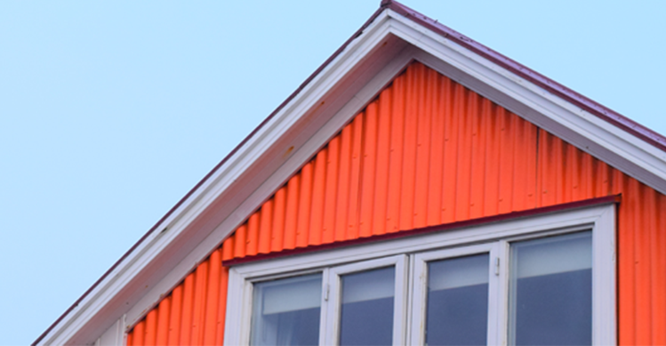 An orange house with a red roof.