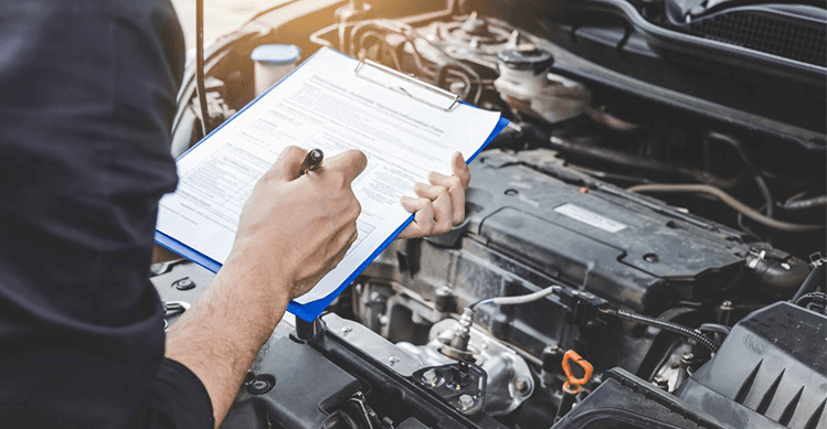 Person checking the vehicle engine.