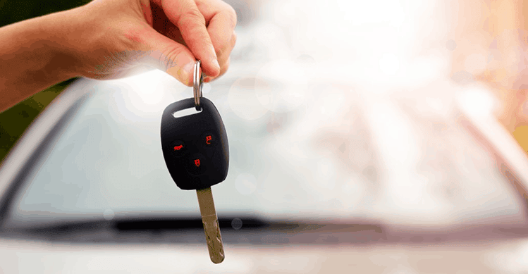 Person holding car key.