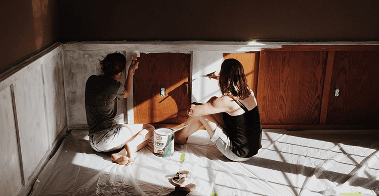 Couple painting their cabinets white.