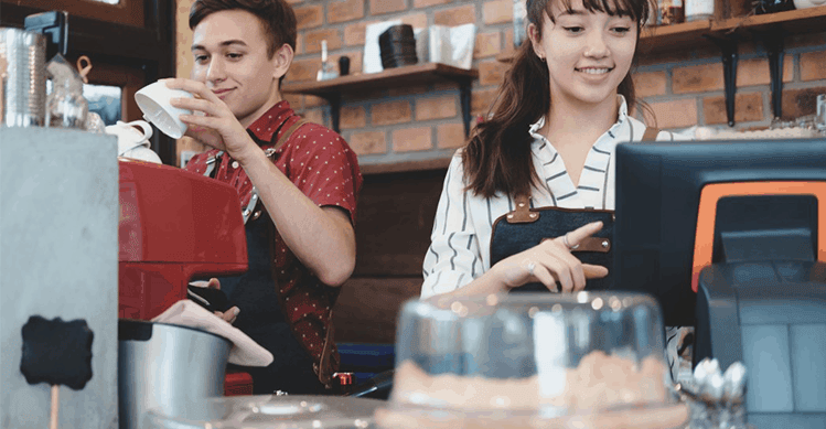 People working in a café behind the counter.